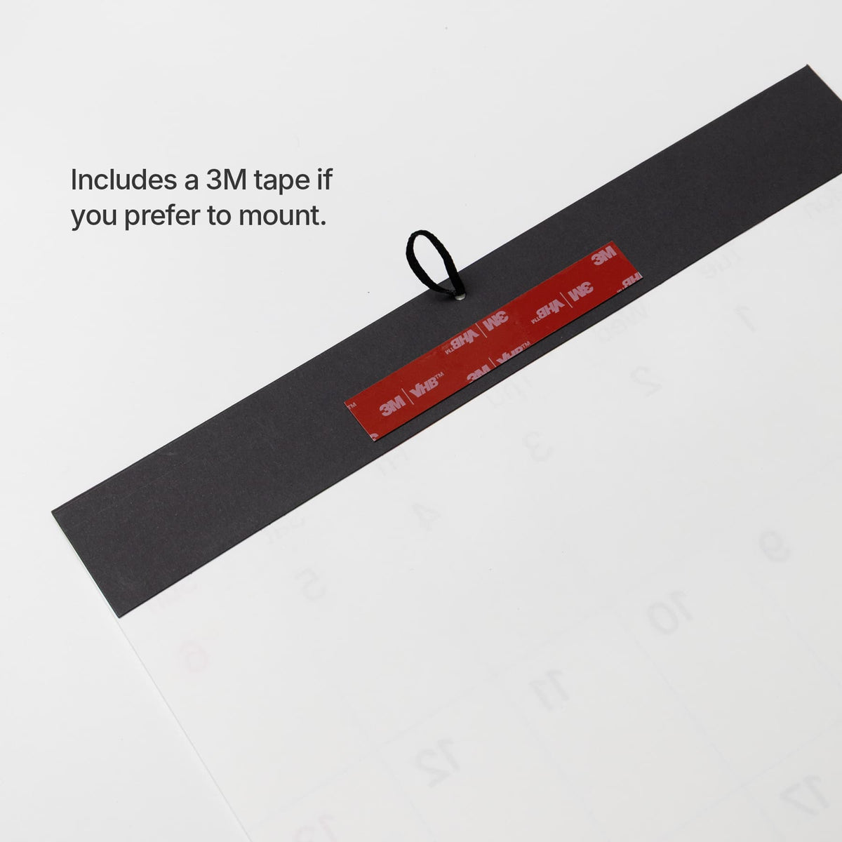 Mounting tape: Back of the Roda wall calendar showing the included 3M mounting tape and hanging loop.