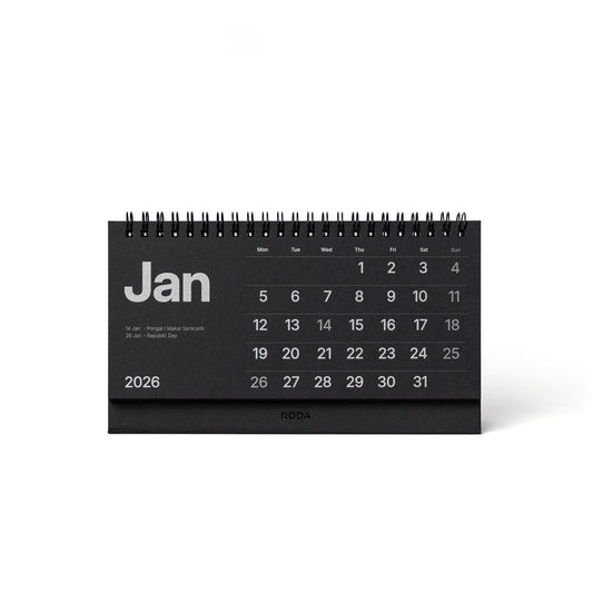 Black desk calendar for January 2026